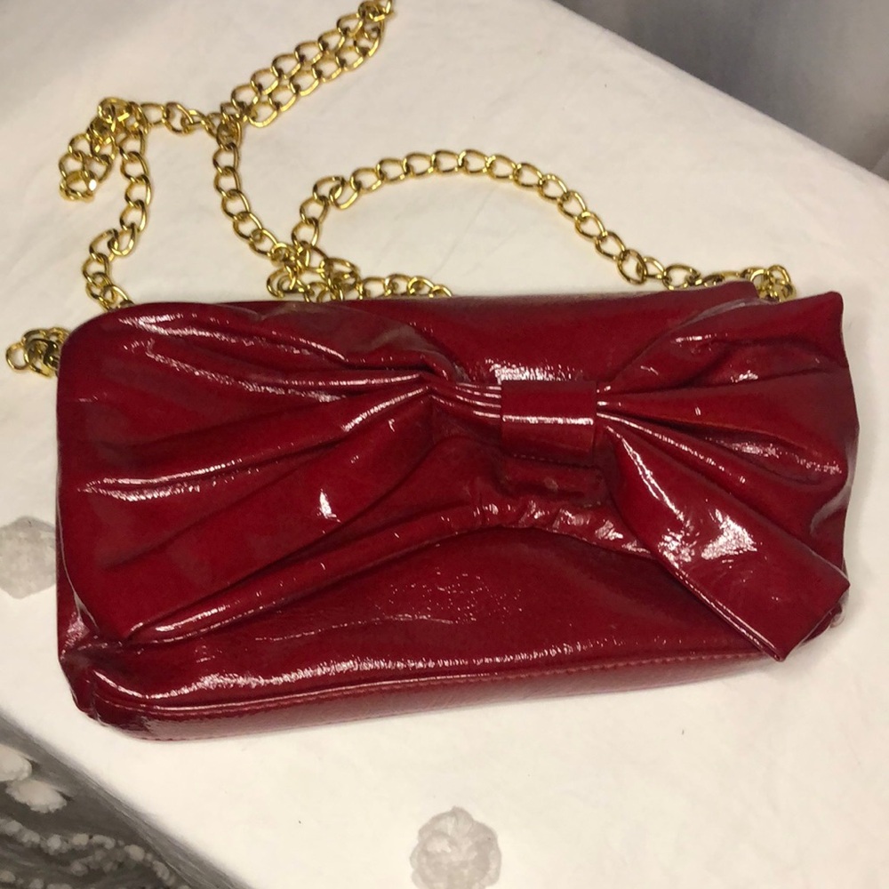 BIG BUDDHA red patent leather handbag w/ chain strap. Large Red bow in front.